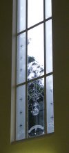 Church window, grey skies beyond