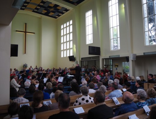 Across audience to strings